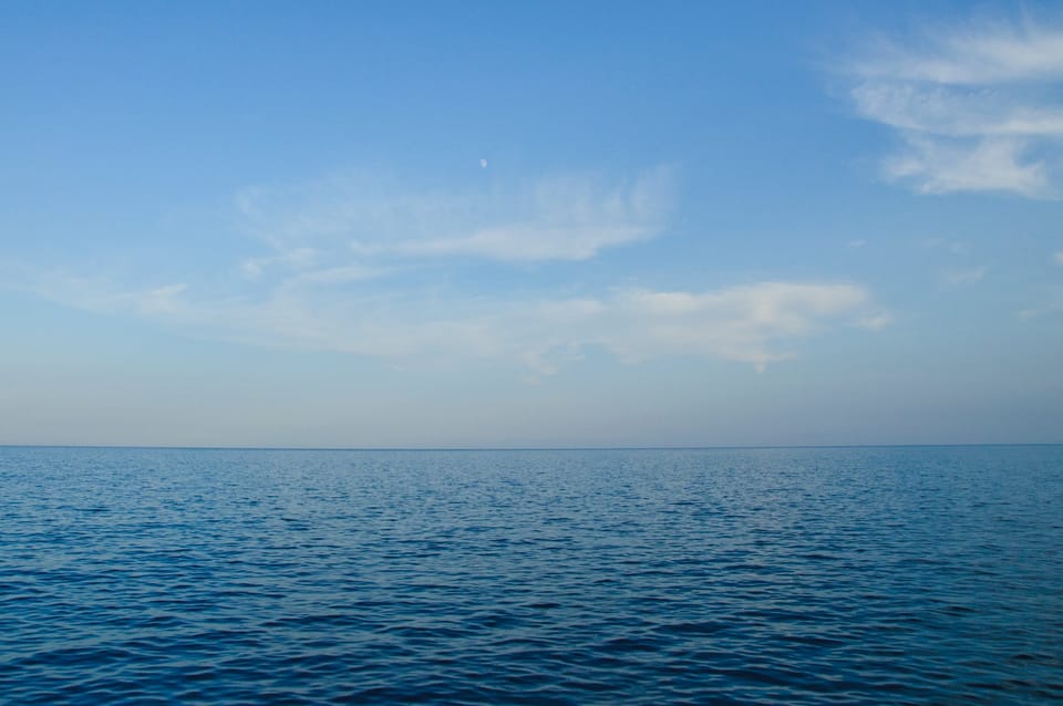 blue body of water under white clouds