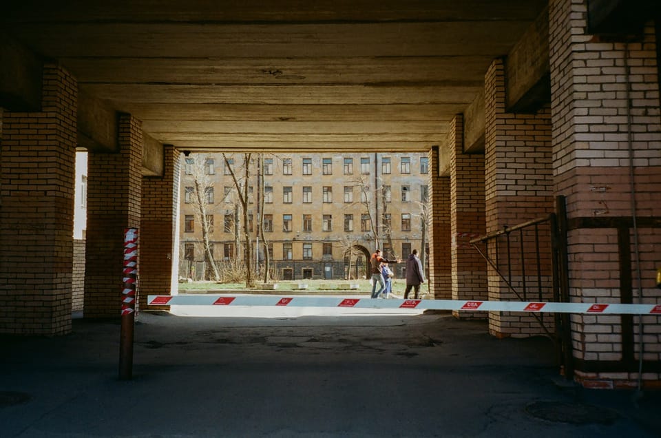 walkway with barrier behind modern multistory house facade in town